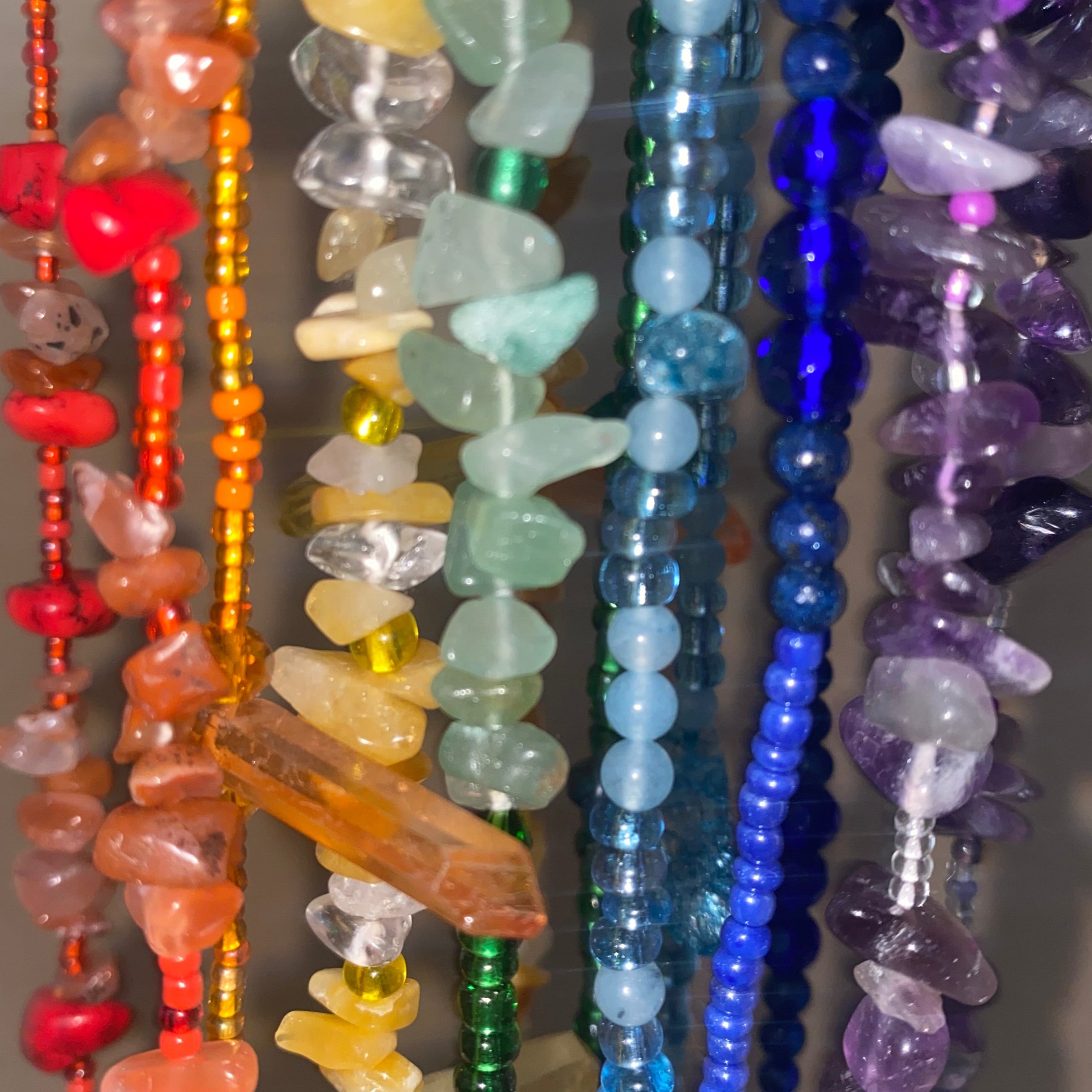Colourful beaded waistbeads on a neutral background